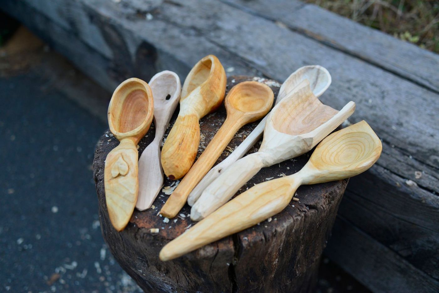 Hand carved wooden spoons on a stump