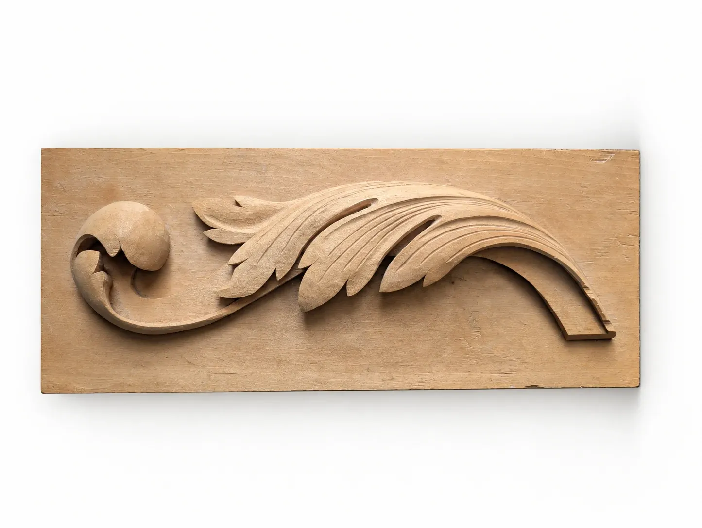 Full view of the hand-carved acanthus leaf relief on its wooden board