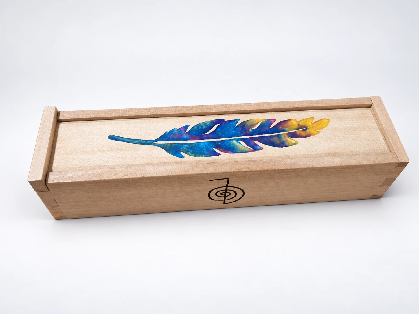 Finished holly box with a painted feather on a white background