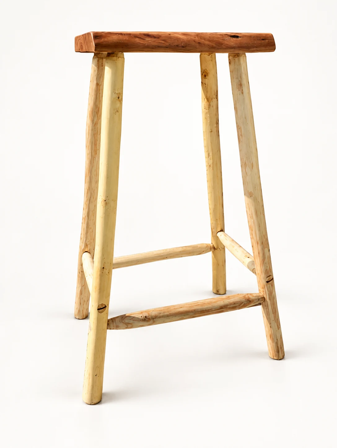 Rear view of the handmade wooden stool showing its branch legs and stretchers