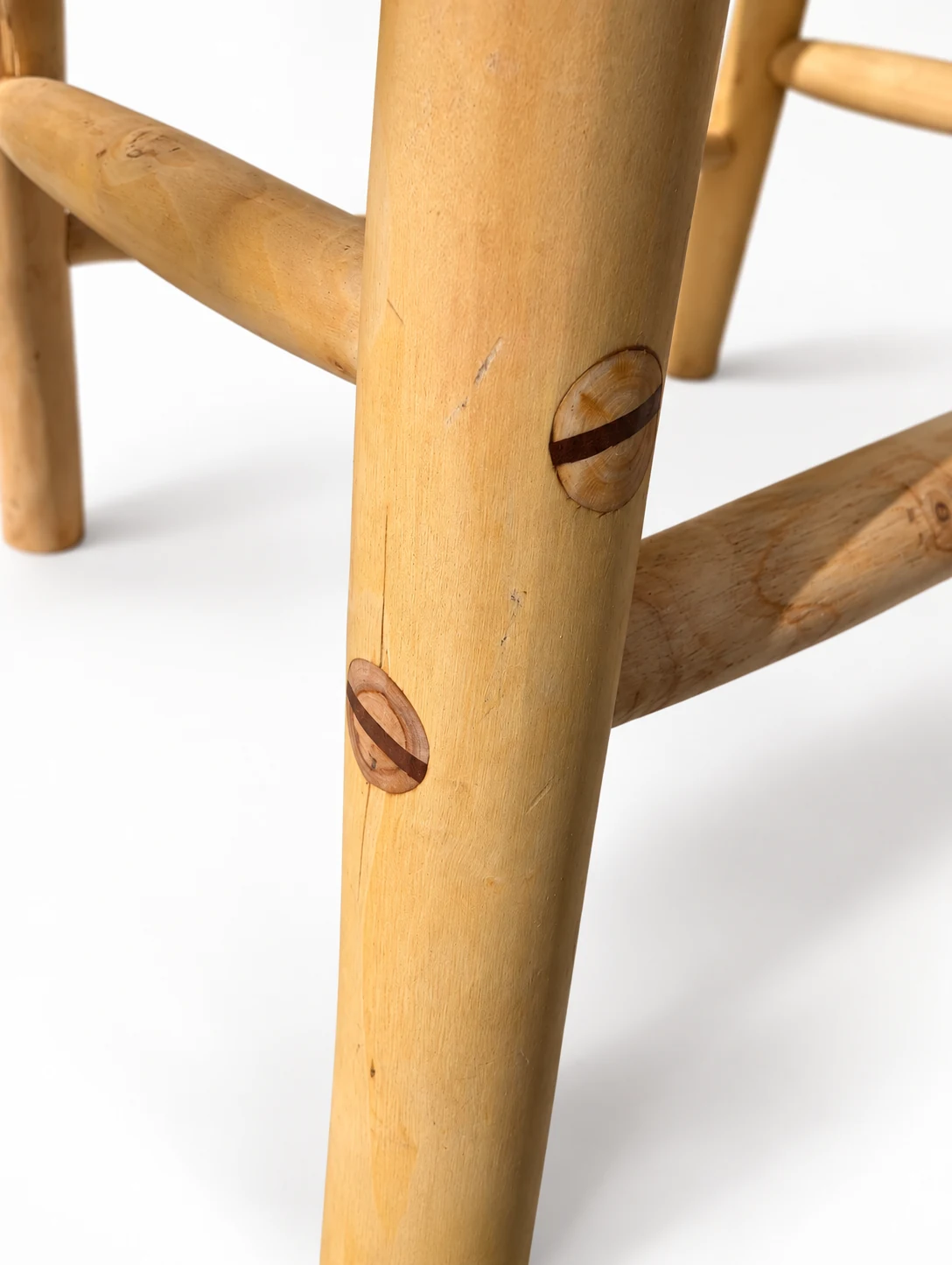 Close detail of the stool leg and its round pegged joints