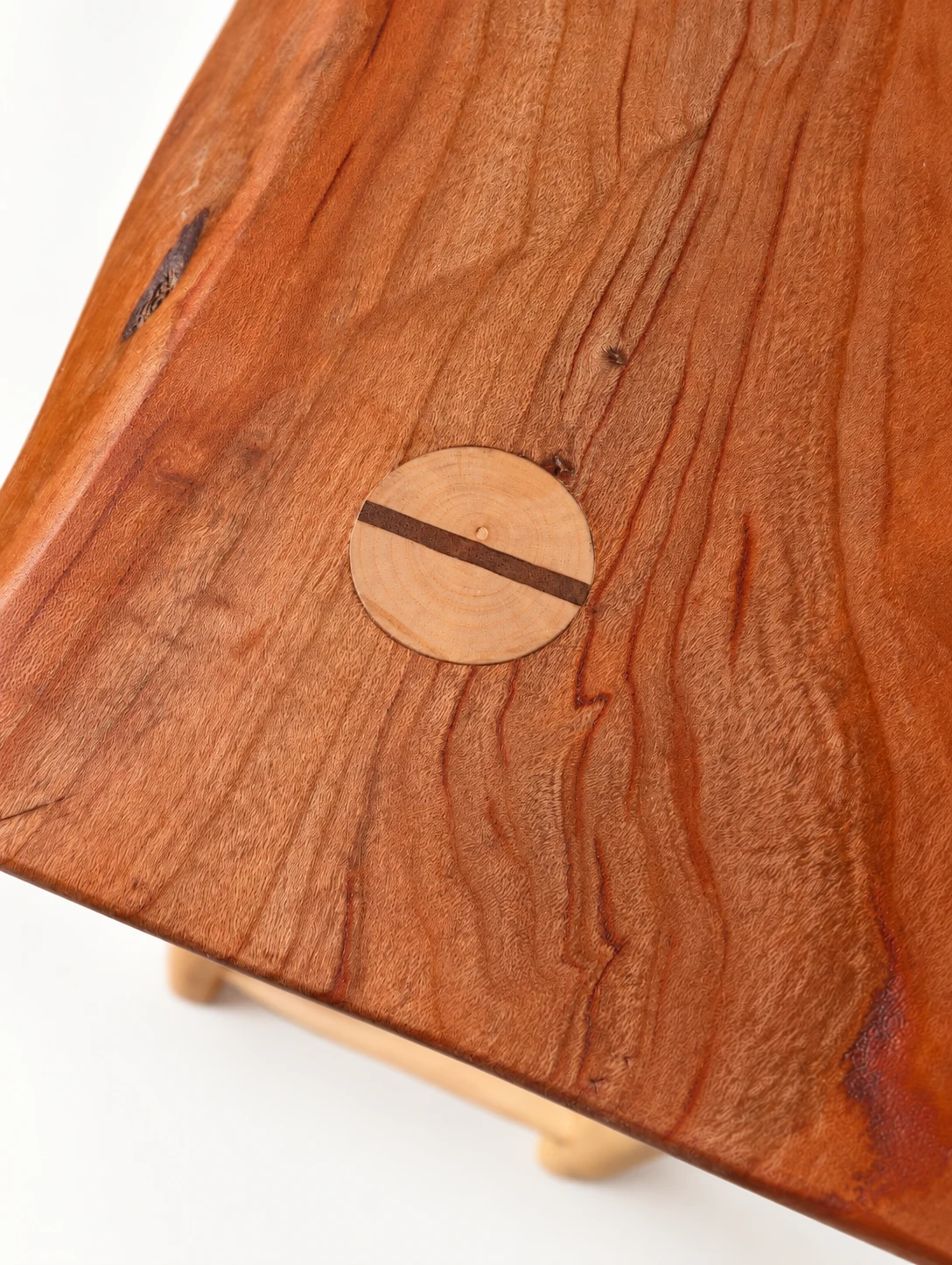 Detail of the wooden seat grain and a circular pegged joint