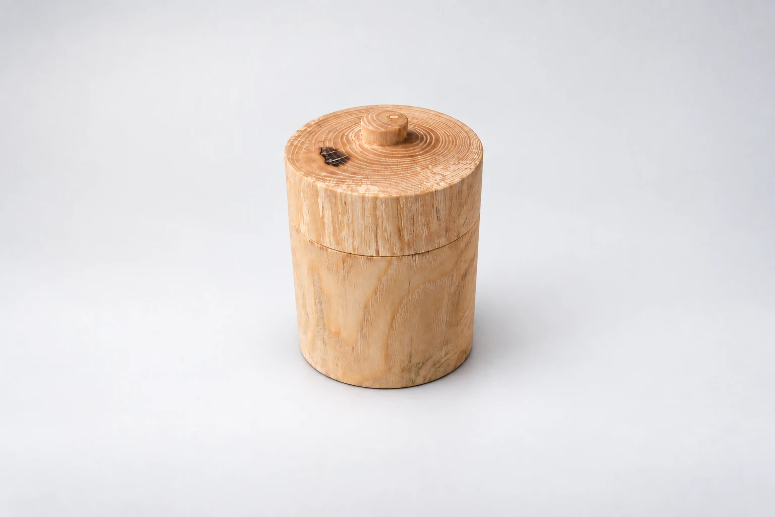 Plain cylindrical wooden vessel with its fitted lid in place