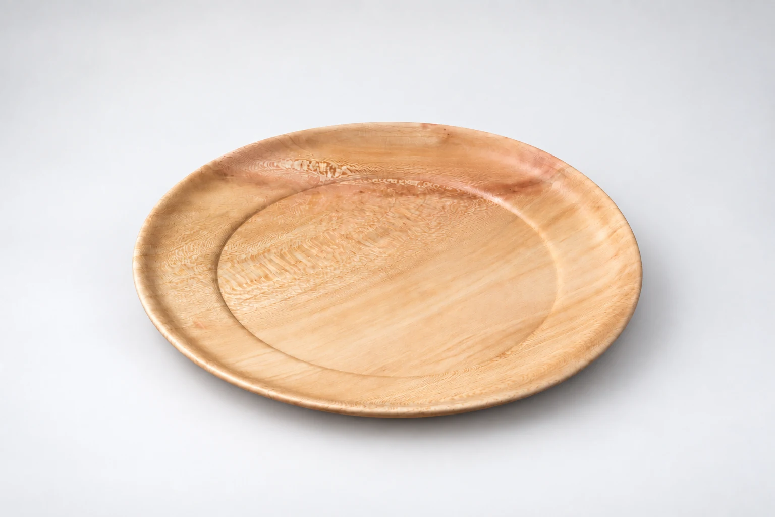 Large shallow wooden platter with figured grain and a turned rim