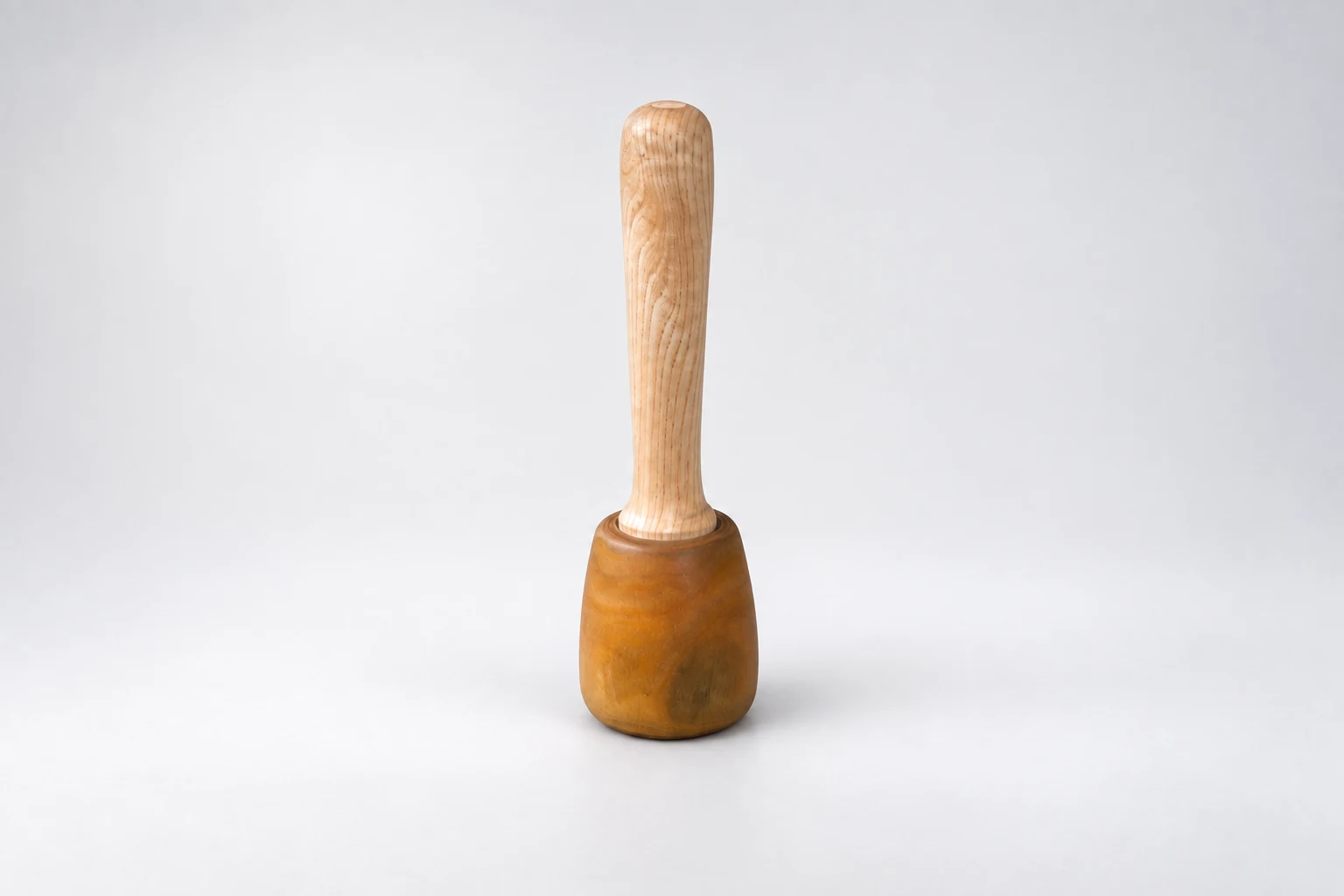 Wooden mallet standing upright on its head