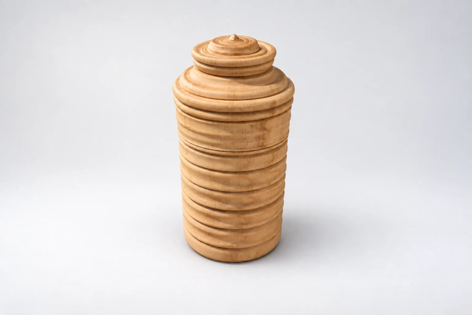 Tall ridged wooden vessel with its stepped lid closed