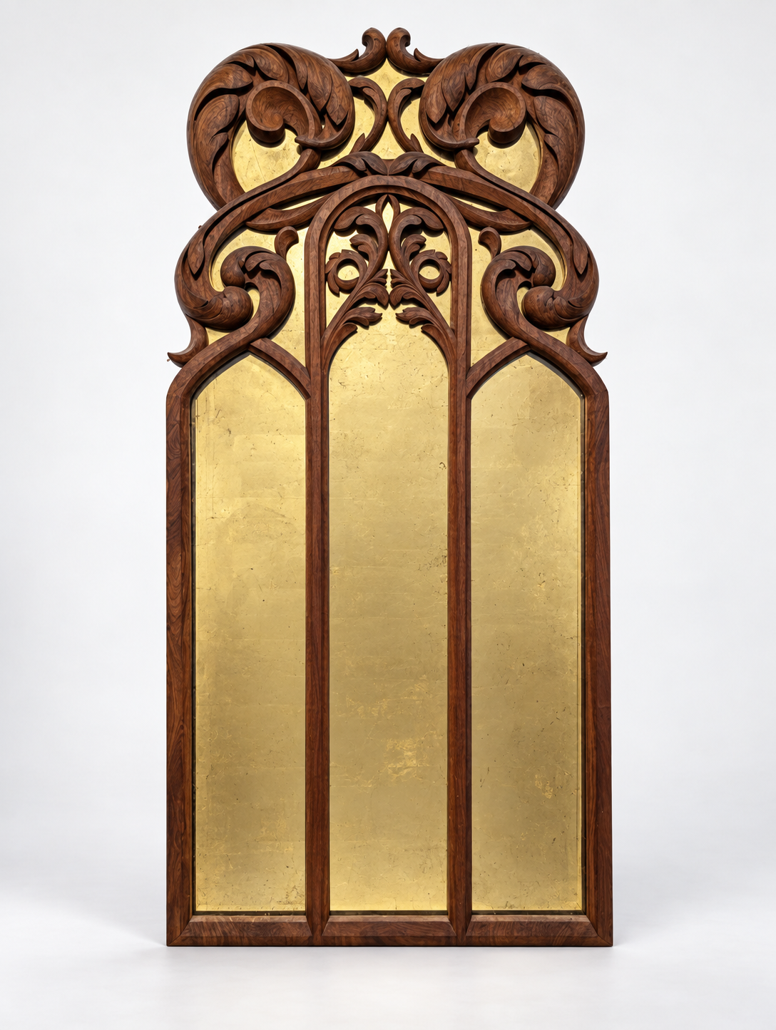 Full view of the carved walnut mirror with gold leaf behind the glass, against a white background