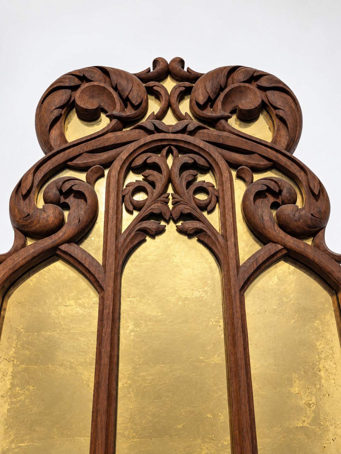 Upper carving and gold-backed glass of the walnut mirror